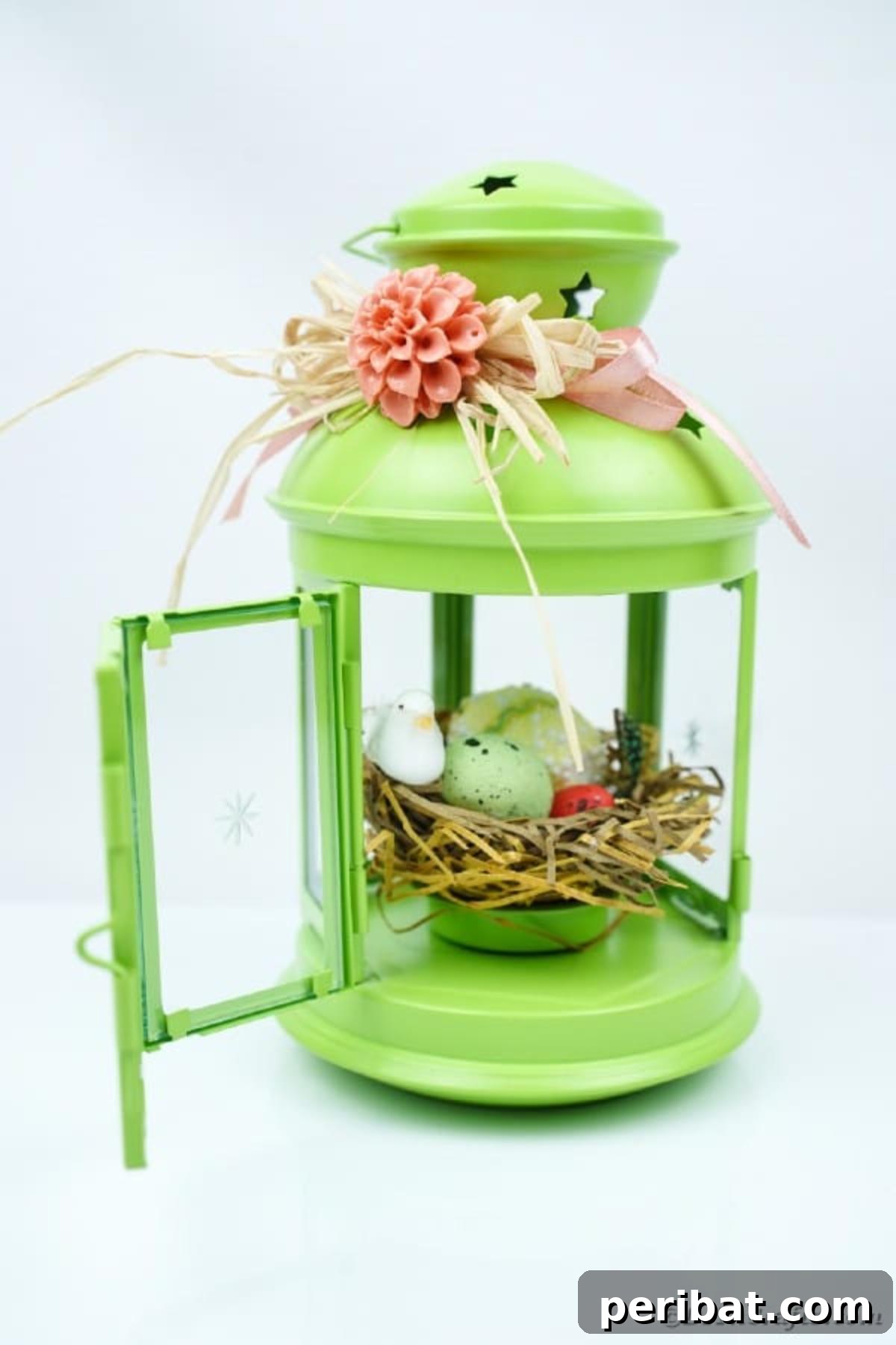 Green lantern with spring decor on white background, showcasing finished craft