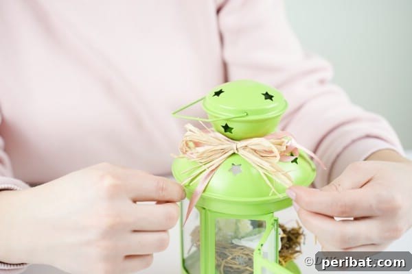 Adding raffia bow to lantern