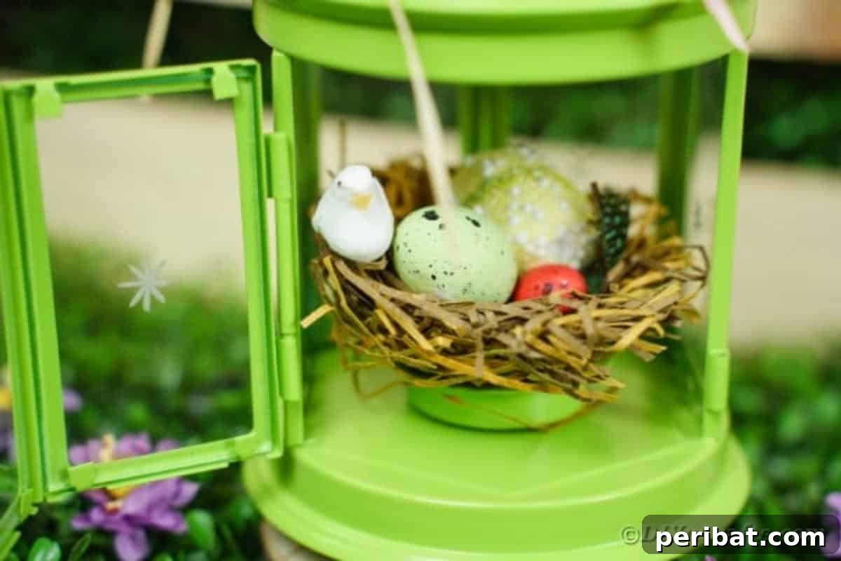 Open door on green lantern with decorative birds nest inside