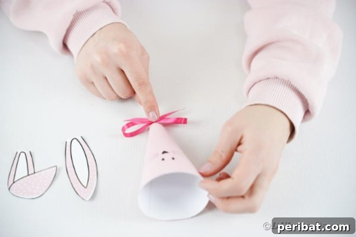 Free Easter Bunny Treat Holder Template 12 Attaching a decorative bow to the bottom of the paper cone with glue
