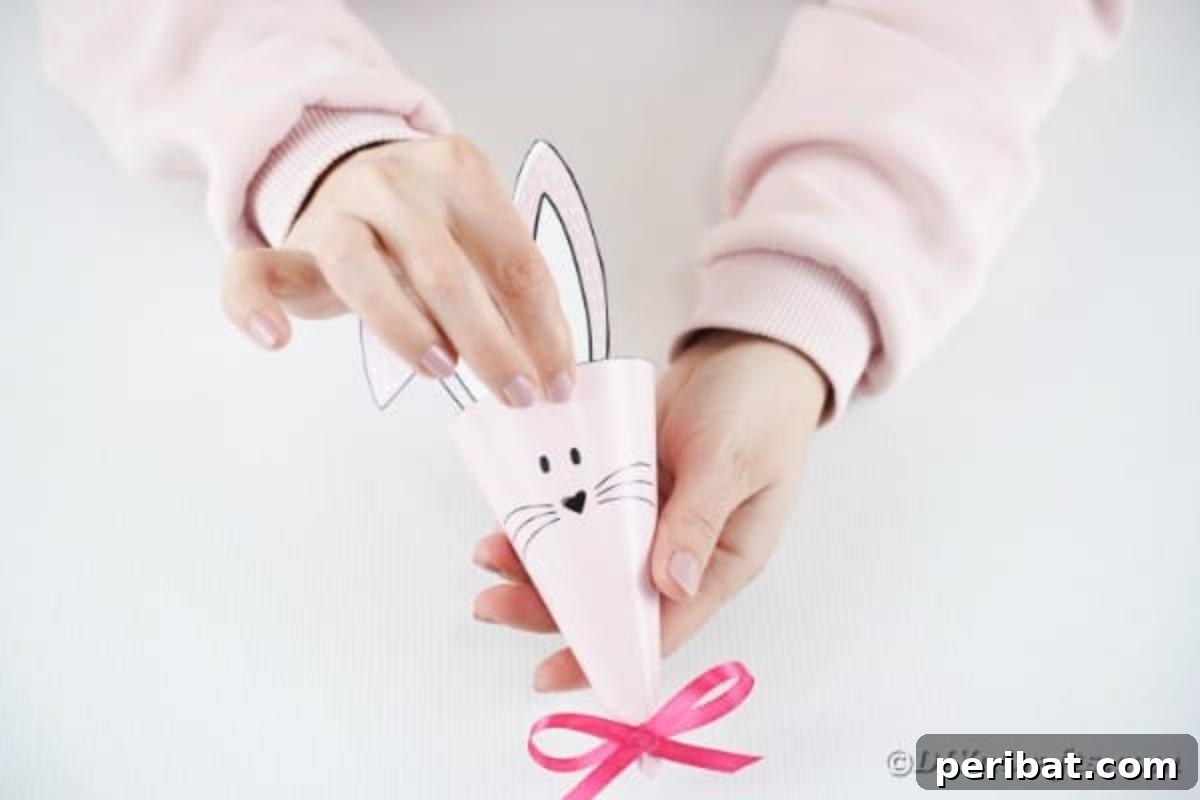 Free Easter Bunny Treat Holder Template 13 Gluing the bunny ears onto the top back of the paper cone