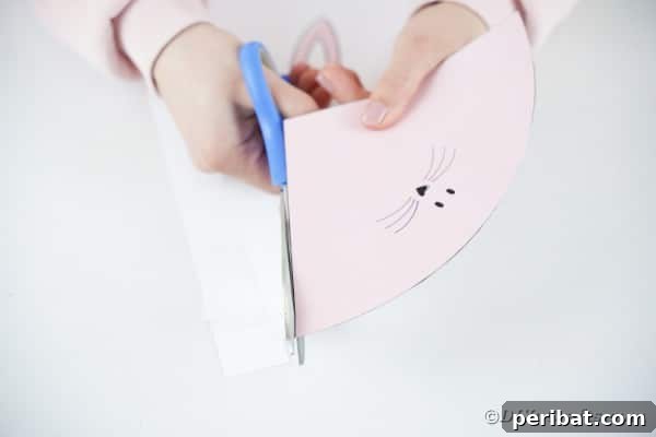 Free Easter Bunny Treat Holder Template 16 Printable Easter bunny being cut outo fp aper