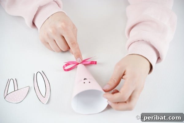Free Easter Bunny Treat Holder Template 20 Gluing bow to bottom of paper cone