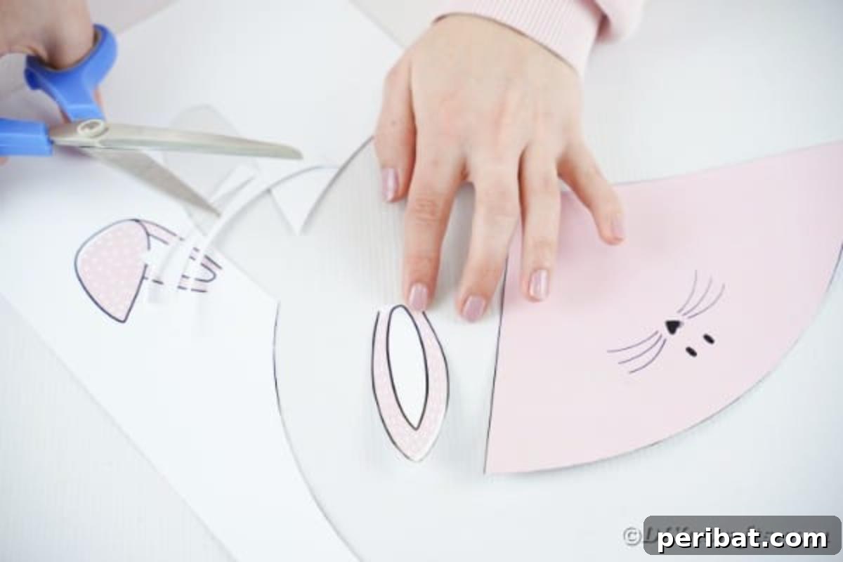 Free Easter Bunny Treat Holder Template 9 Hands cutting out the bunny ears from paper for the craft