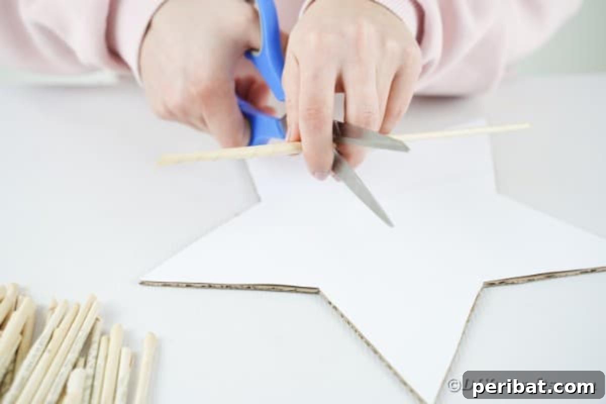 Literary Starburst Wall Decor 13 Hands measuring and cutting pre-rolled book pages to specific lengths to fit the edges of the star base.