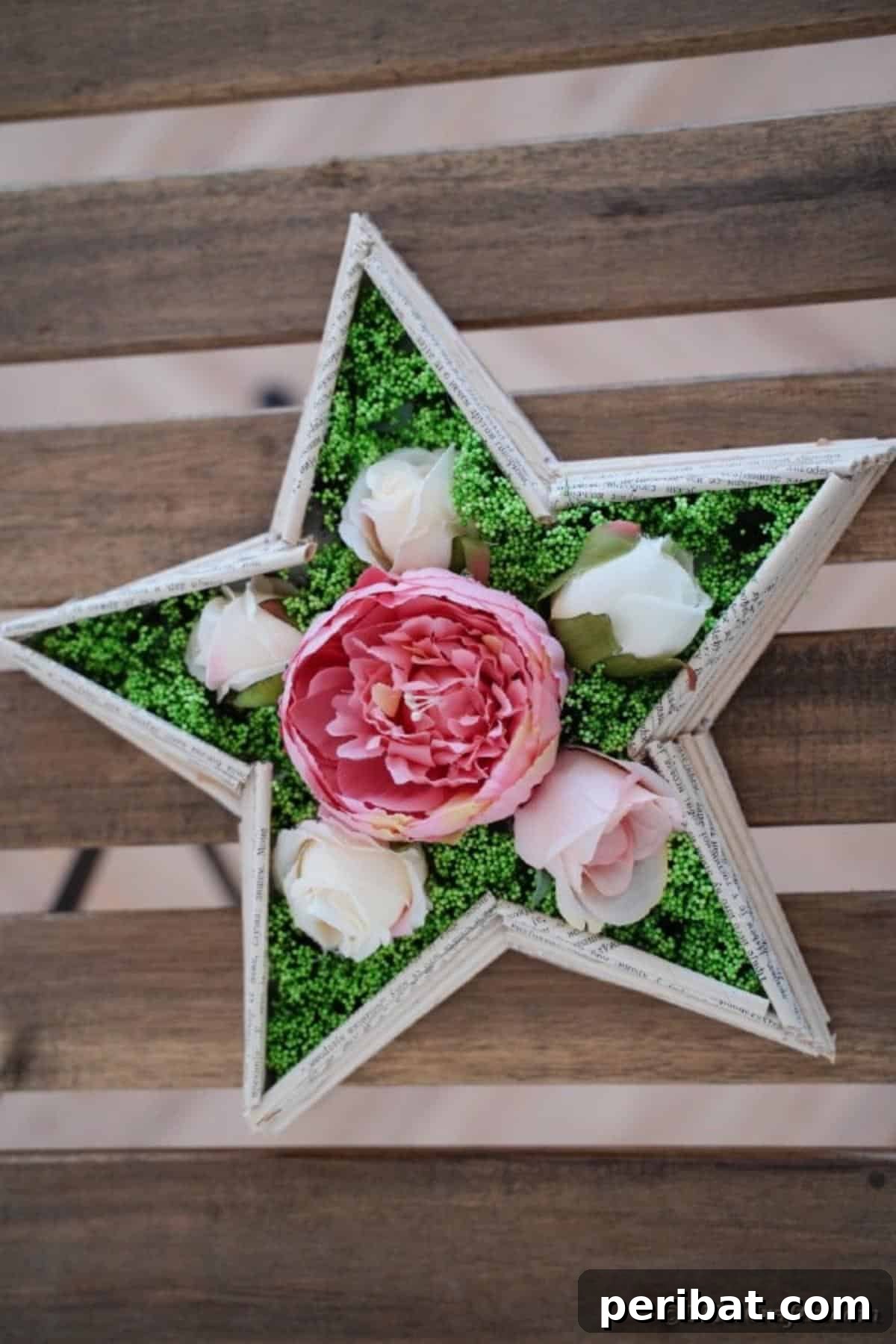 Literary Starburst Wall Decor 6 A finished old book page star wall art decoration lying on a rustic wooden table, ready for display.