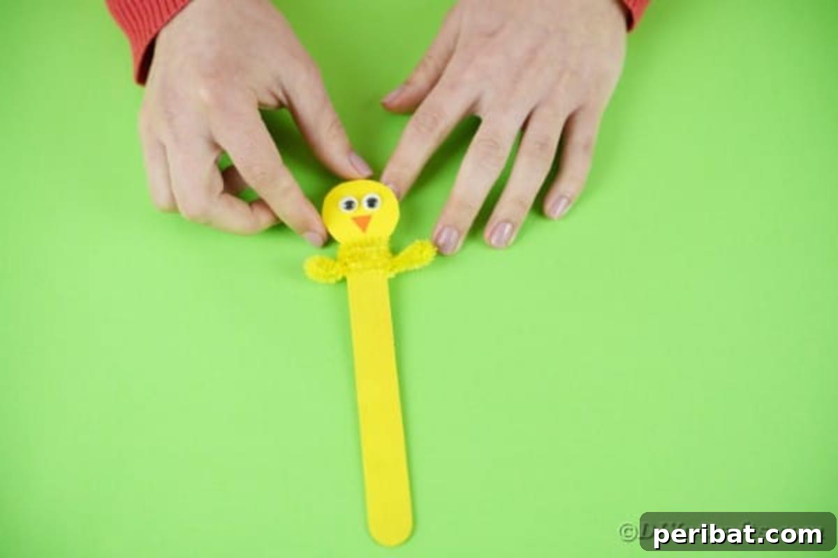 Popsicle Stick Easter Critter Bookmarks 17 Adding pipe cleaner to craft stick for arms