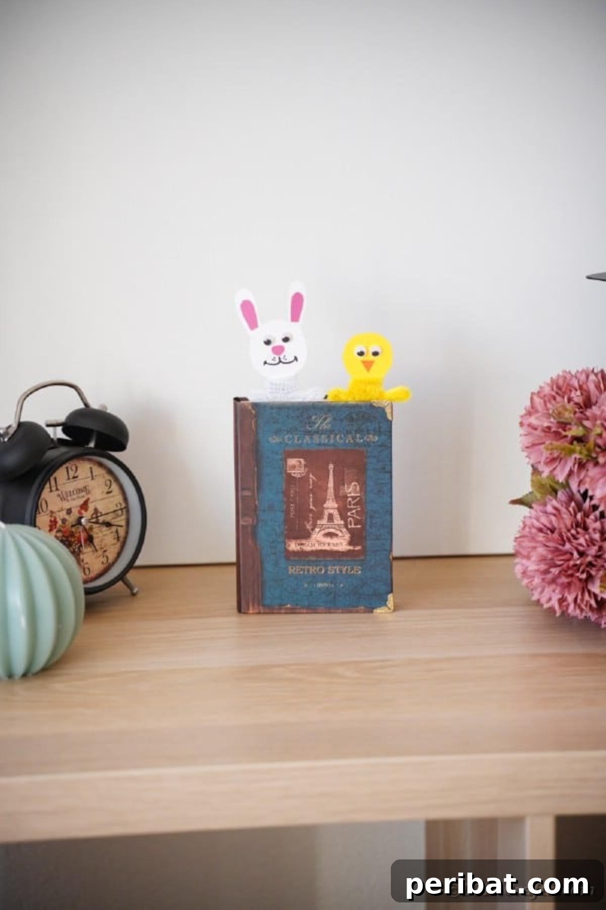 Popsicle Stick Easter Critter Bookmarks 3 Easter bookmarks in a book on table