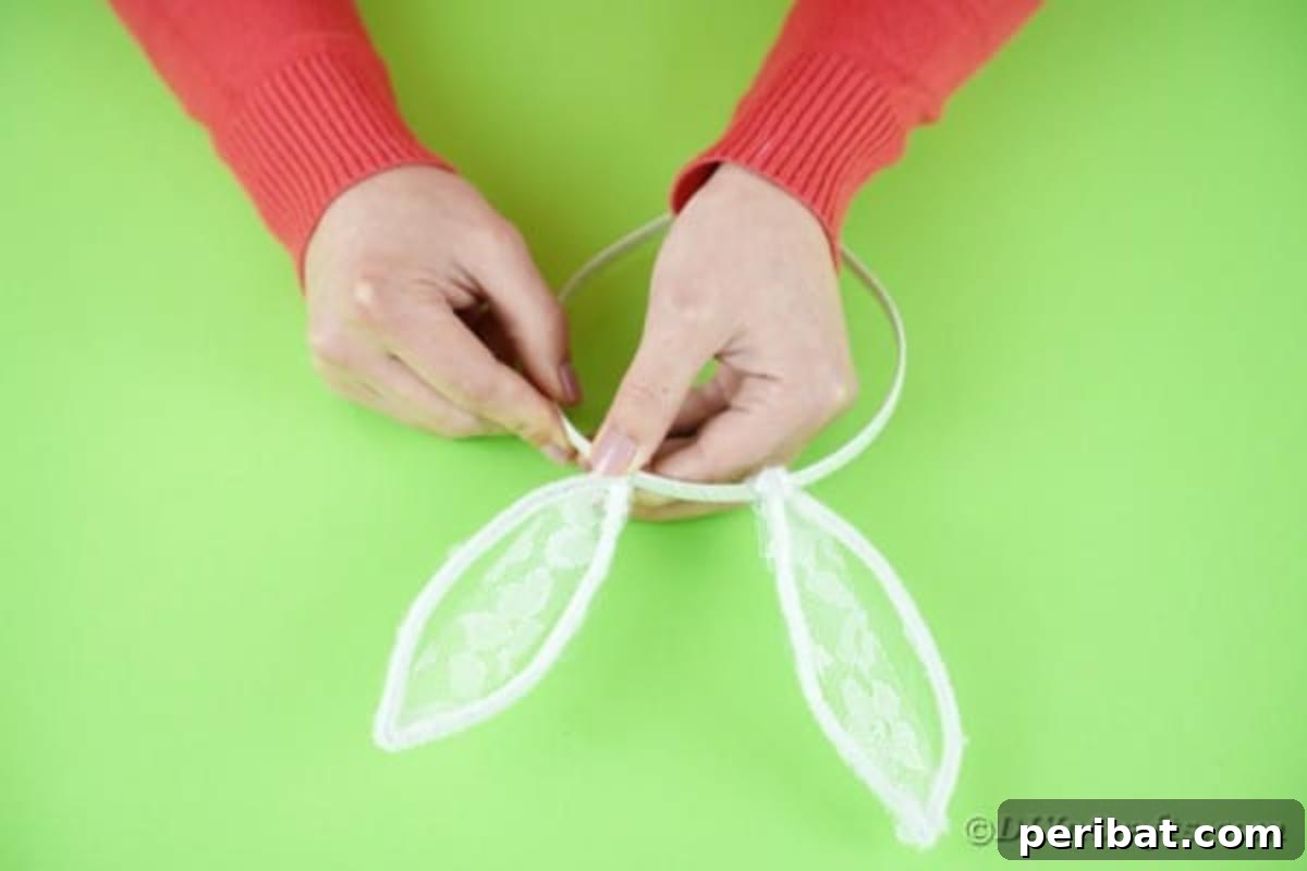 Firmly gluing the lace bunny ear to the plastic headband