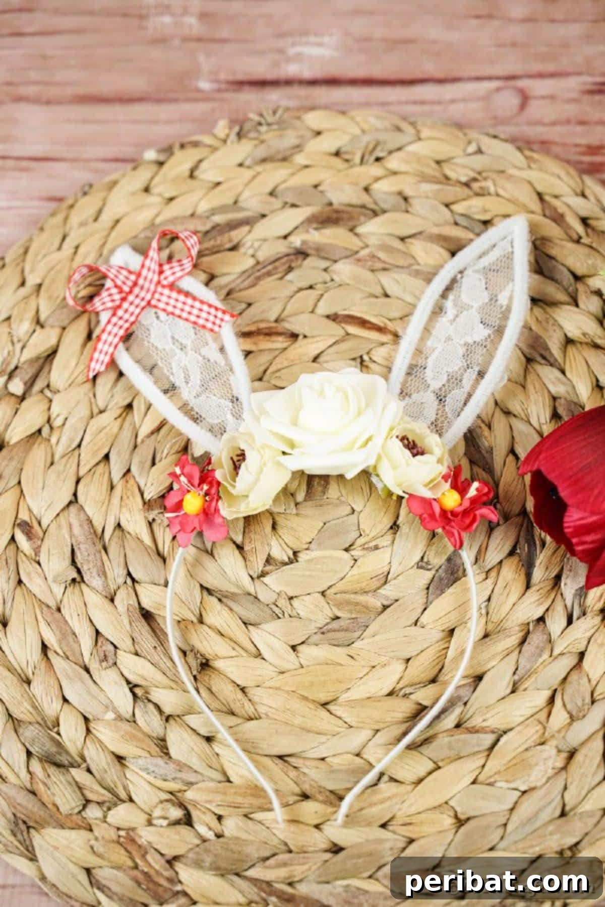 Lace bunny ears headband gracefully displayed on a woven mat