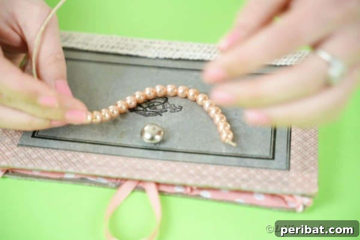 Old Books New Fashion DIY Book Purse Tutorial 16 Expertly threading fake pearls onto a length of twine to create a sophisticated and elegant beaded handle for the upcycled old book purse