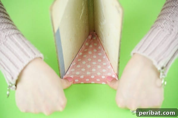 Old Books New Fashion DIY Book Purse Tutorial 22 Gluing fabric onto sides of book