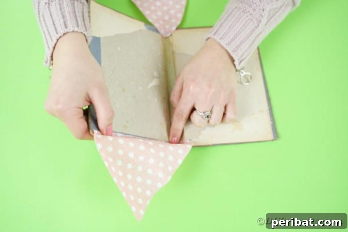 Old Books New Fashion DIY Book Purse Tutorial 9 Applying craft glue to the inside of the book cover, preparing to attach the first fabric side panel for the DIY book purse, emphasizing careful placement