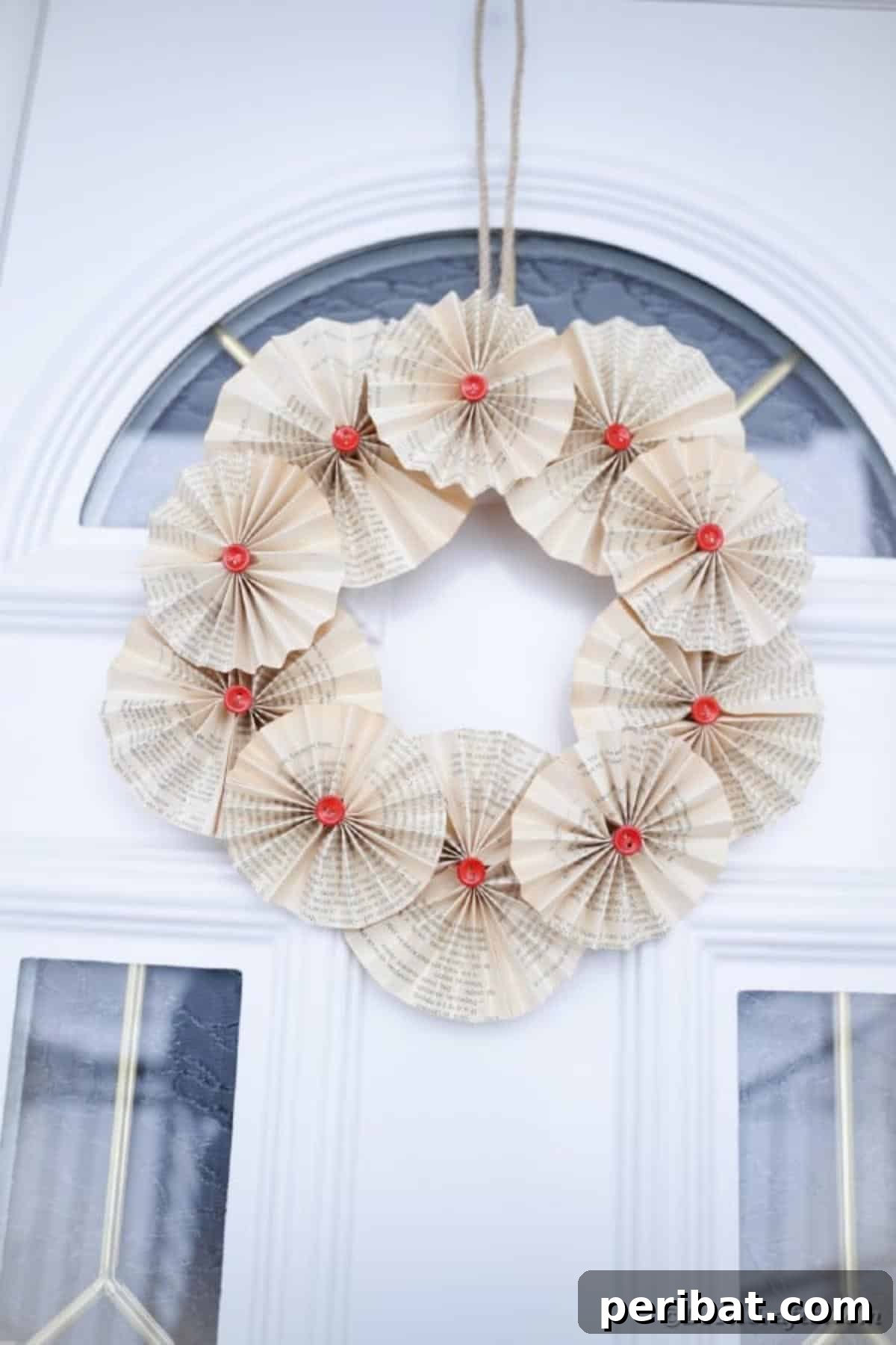 Enchanting Vintage Book Page Wreath Craft 19 The finished rustic old book page wreath hanging beautifully on a glass door.