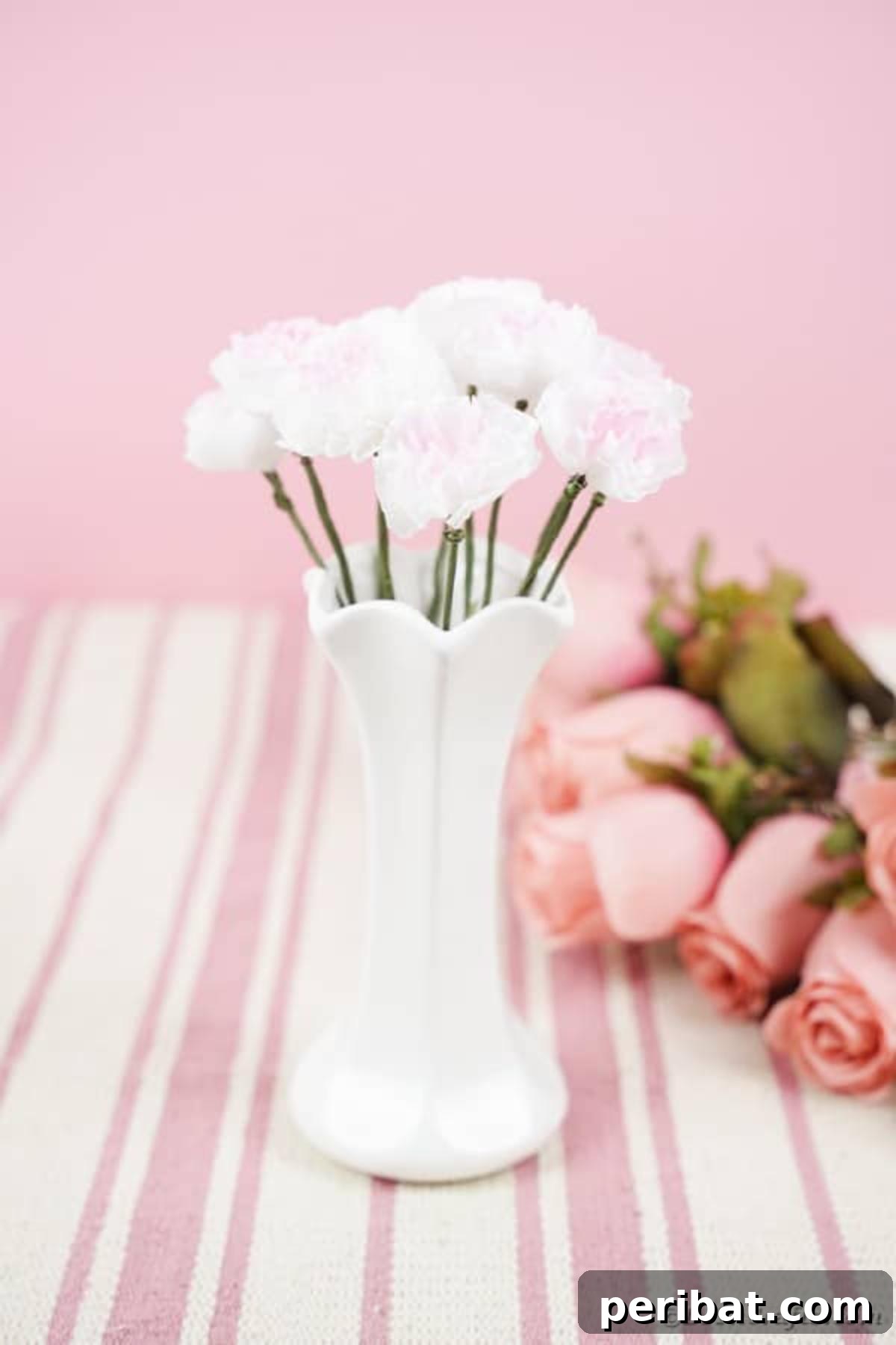 Craft Vibrant Tissue Blooms Video Tutorial 13 A beautiful arrangement of handmade tissue paper flowers displayed in a white vase on a pink table