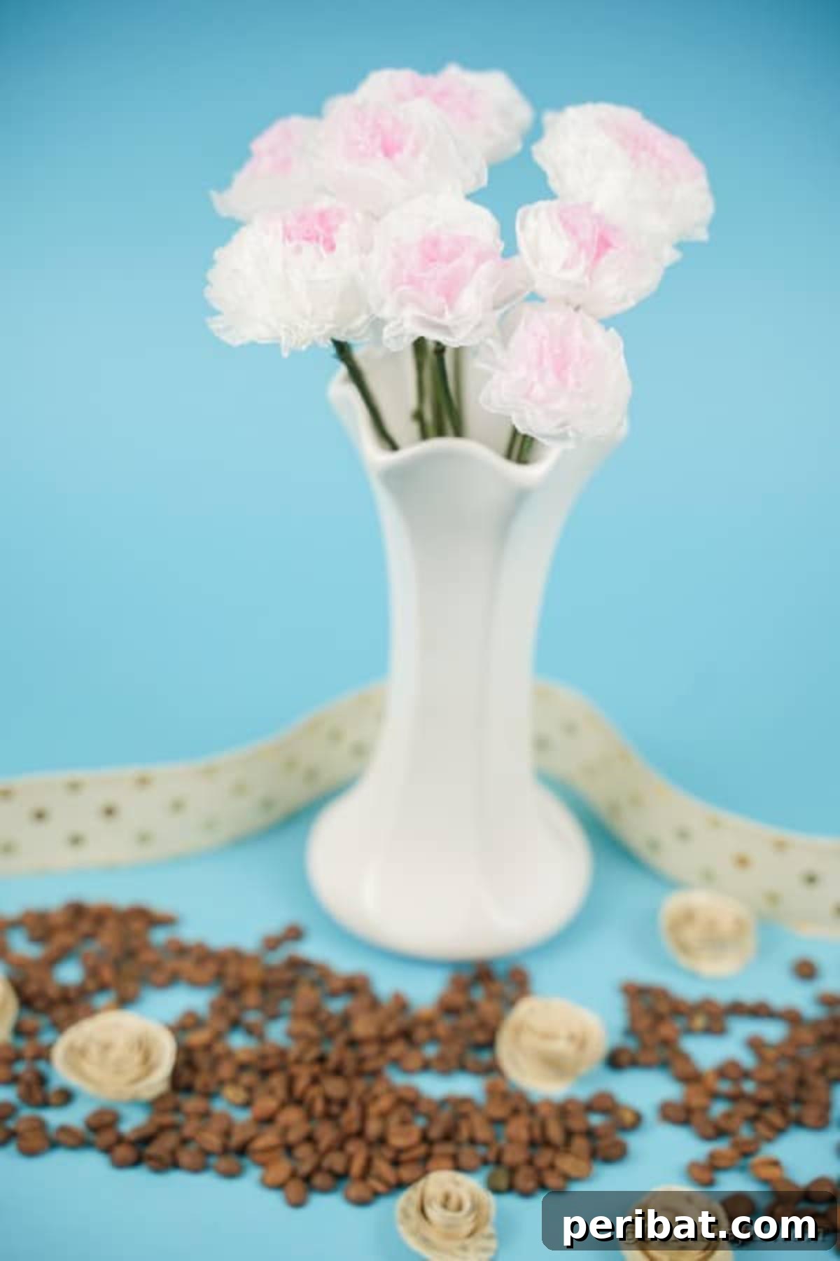 Craft Vibrant Tissue Blooms Video Tutorial 4 White vase filled with charming tissue paper flowers, placed on a blue counter