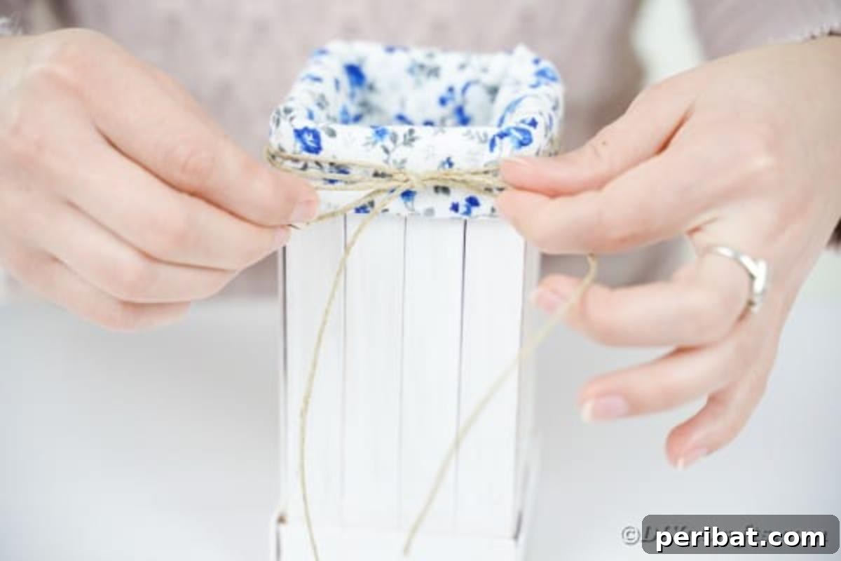 Craft Your Own Milk Carton Organizer Tutorial 14 Adding a twine bow to front of organizer