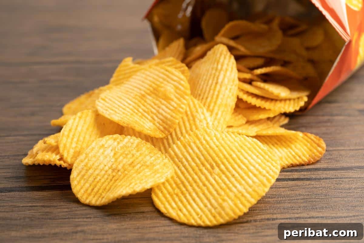 A bag of chips spilled across the table, illustrating how dry snacks can be preserved by freezing to maintain crispness.