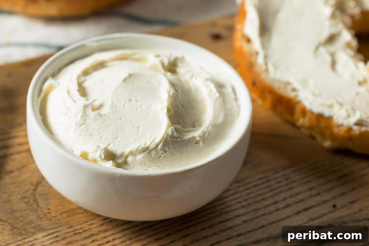A bowl full of cream cheese, a versatile dairy product that can be frozen for later use in cooking and baking.