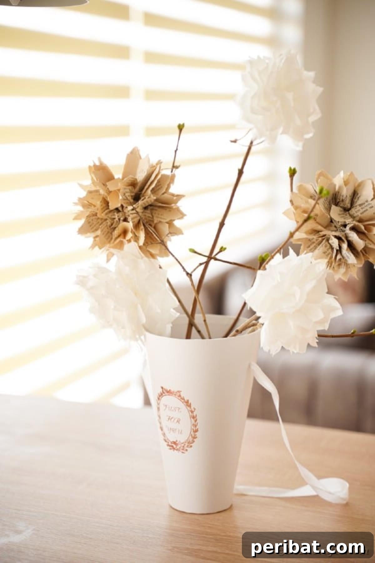 Tall cup filled with old book page flowers on sticks