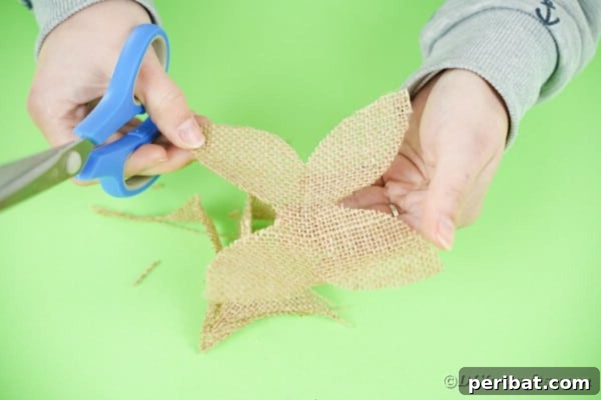An unfolded piece of burlap shaped into four rounded leaves