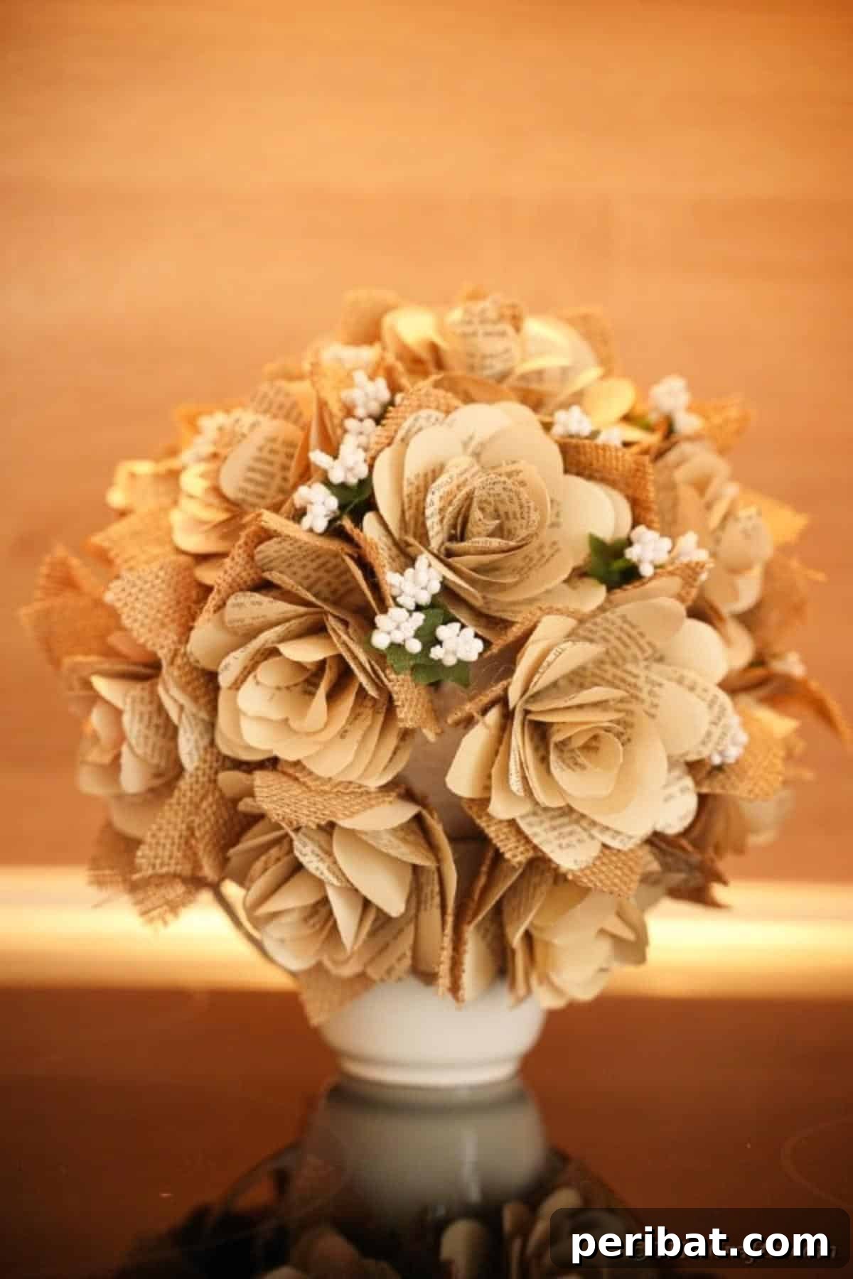 A beautifully crafted book page rose bouquet displayed on a dark wooden table