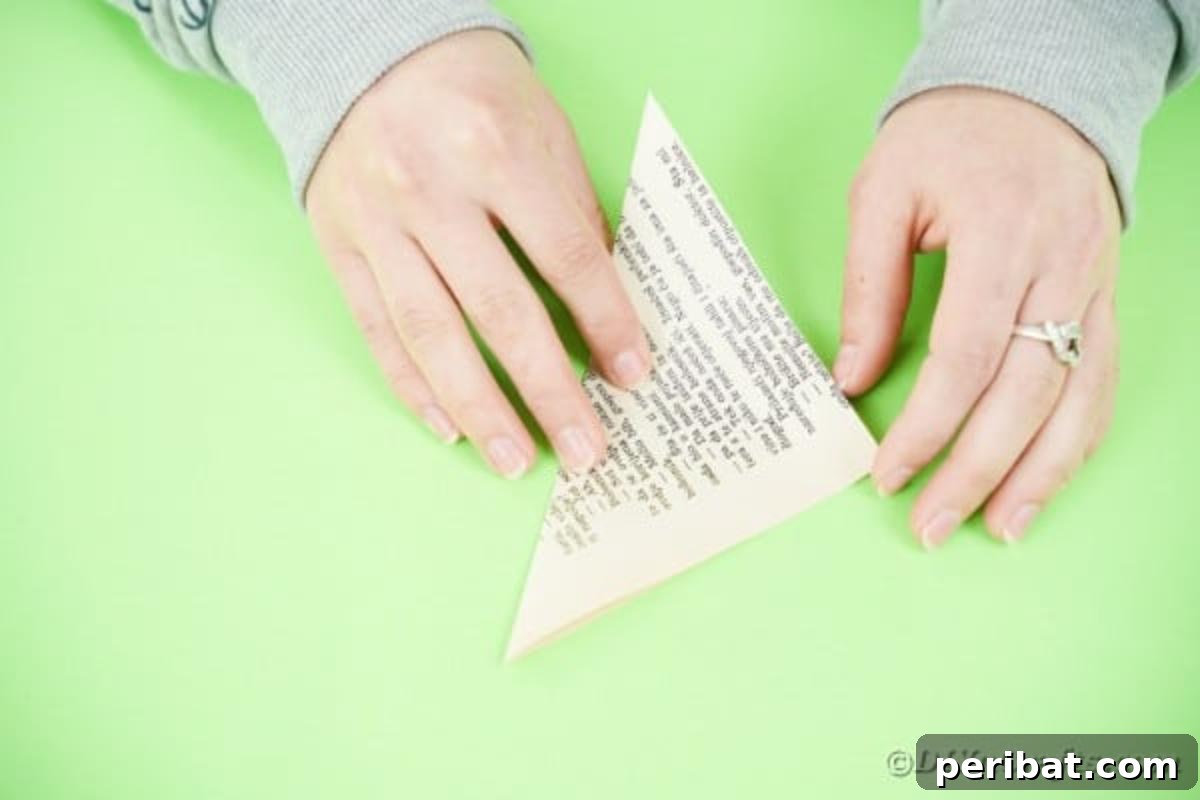 A book page folded into a large paper triangle