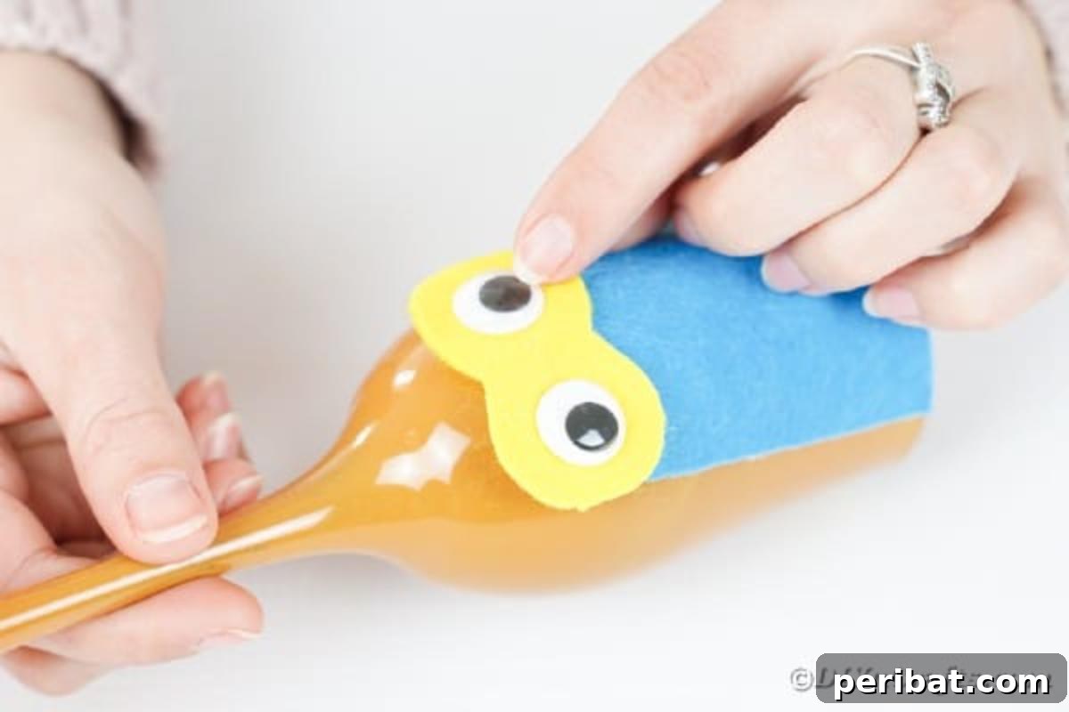 Craft Your Own Adorable Wine Glass Owl 14 Gluing googly eyes onto yellow paper