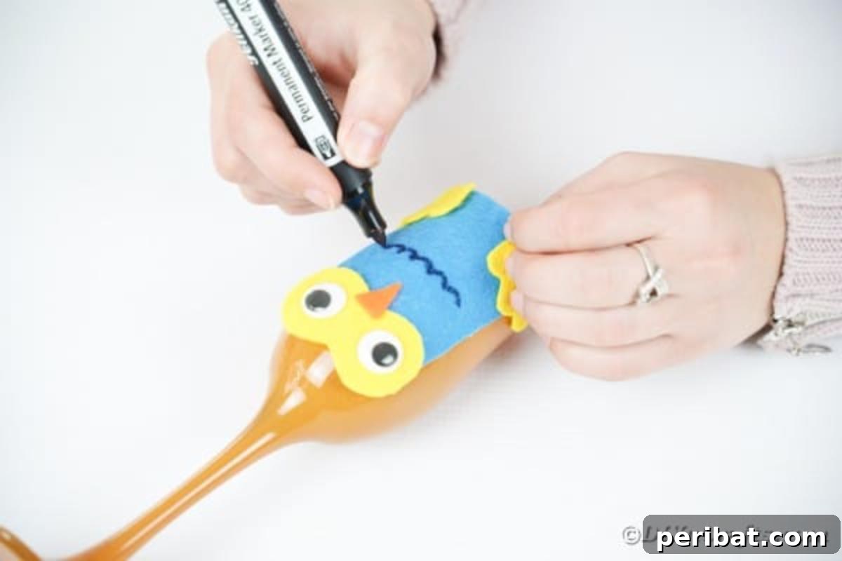 Craft Your Own Adorable Wine Glass Owl 17 Drawing feathers onto owl