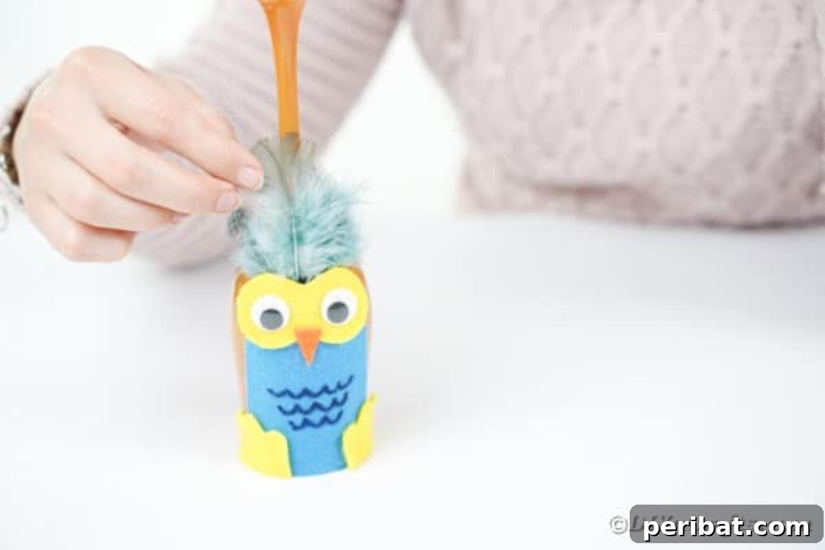 Craft Your Own Adorable Wine Glass Owl 18 Gluing feathers to wine glass owl