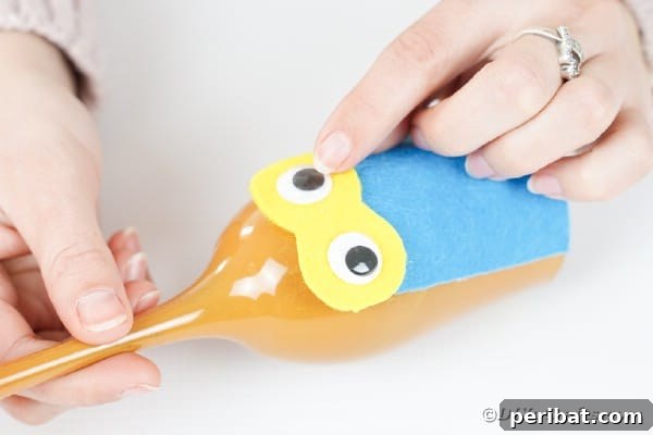 Craft Your Own Adorable Wine Glass Owl 27 Gluing googly eyes onto yellow paper