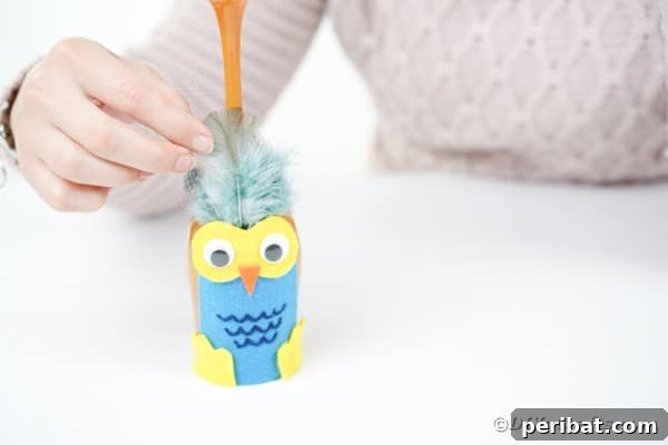 Craft Your Own Adorable Wine Glass Owl 31 Gluing feathers to wine glass owl