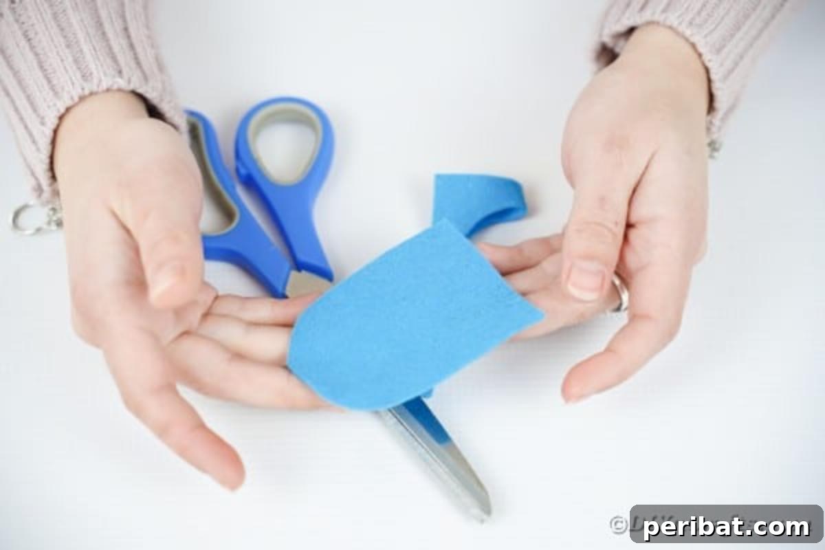 Craft Your Own Adorable Wine Glass Owl 9 Cutting owl body out of blue paper