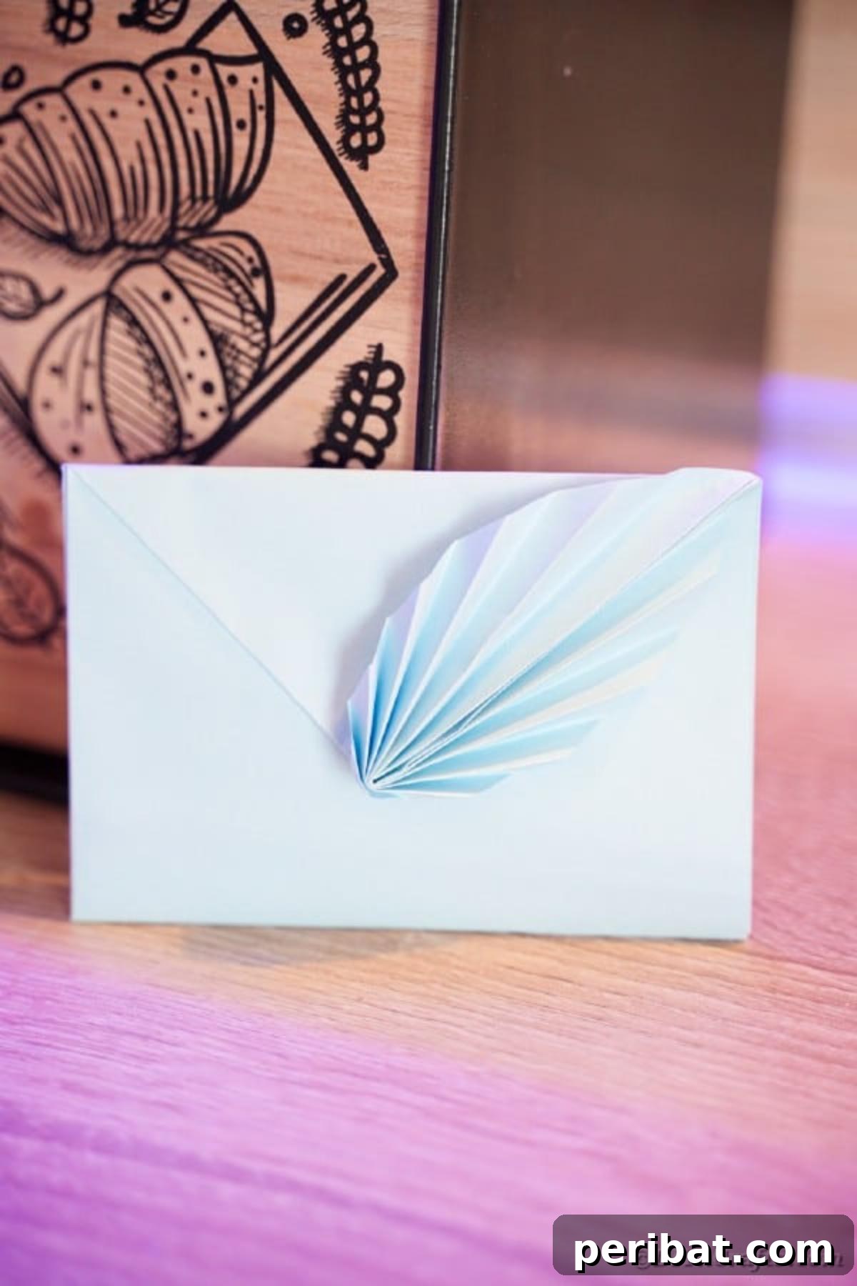 Elegant Origami Envelopes: A DIY Paper Craft Video Tutorial 5 Blue envelope leaned against wood