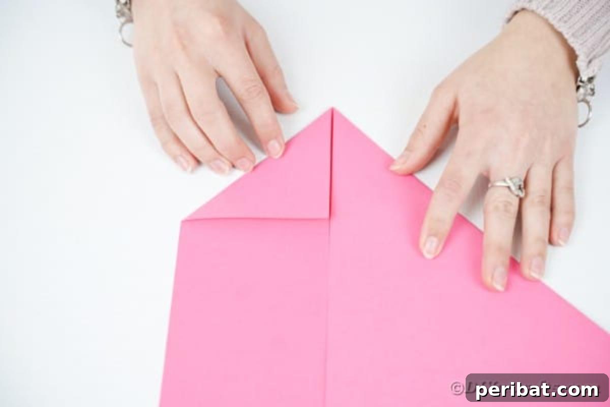 Elegant Origami Envelopes: A DIY Paper Craft Video Tutorial 9 Folding edges of pink paper