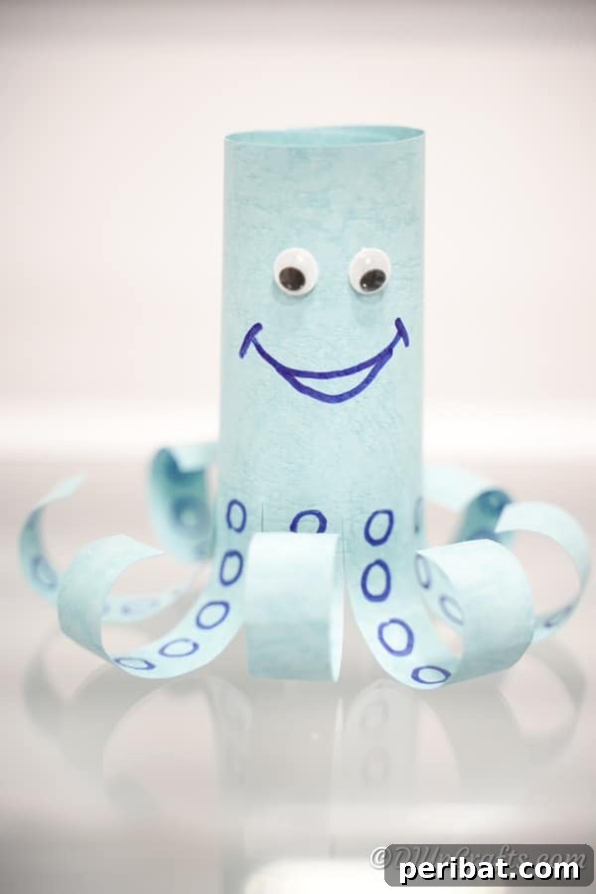 Bright blue paper octopus sitting on a wooden table