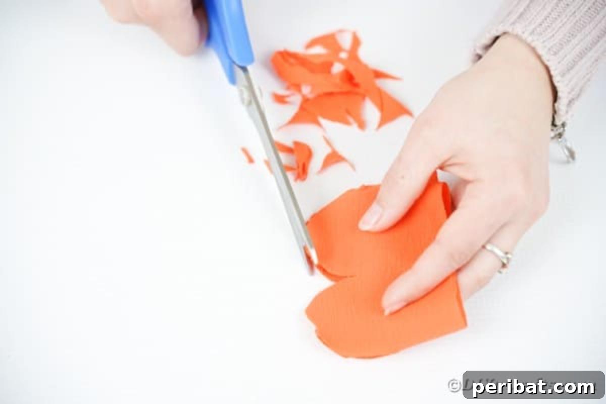 Your Easy Guide to Fabric Flower Bouquets Video 11 Cutting a rounded, scalloped edge on folded orange fabric