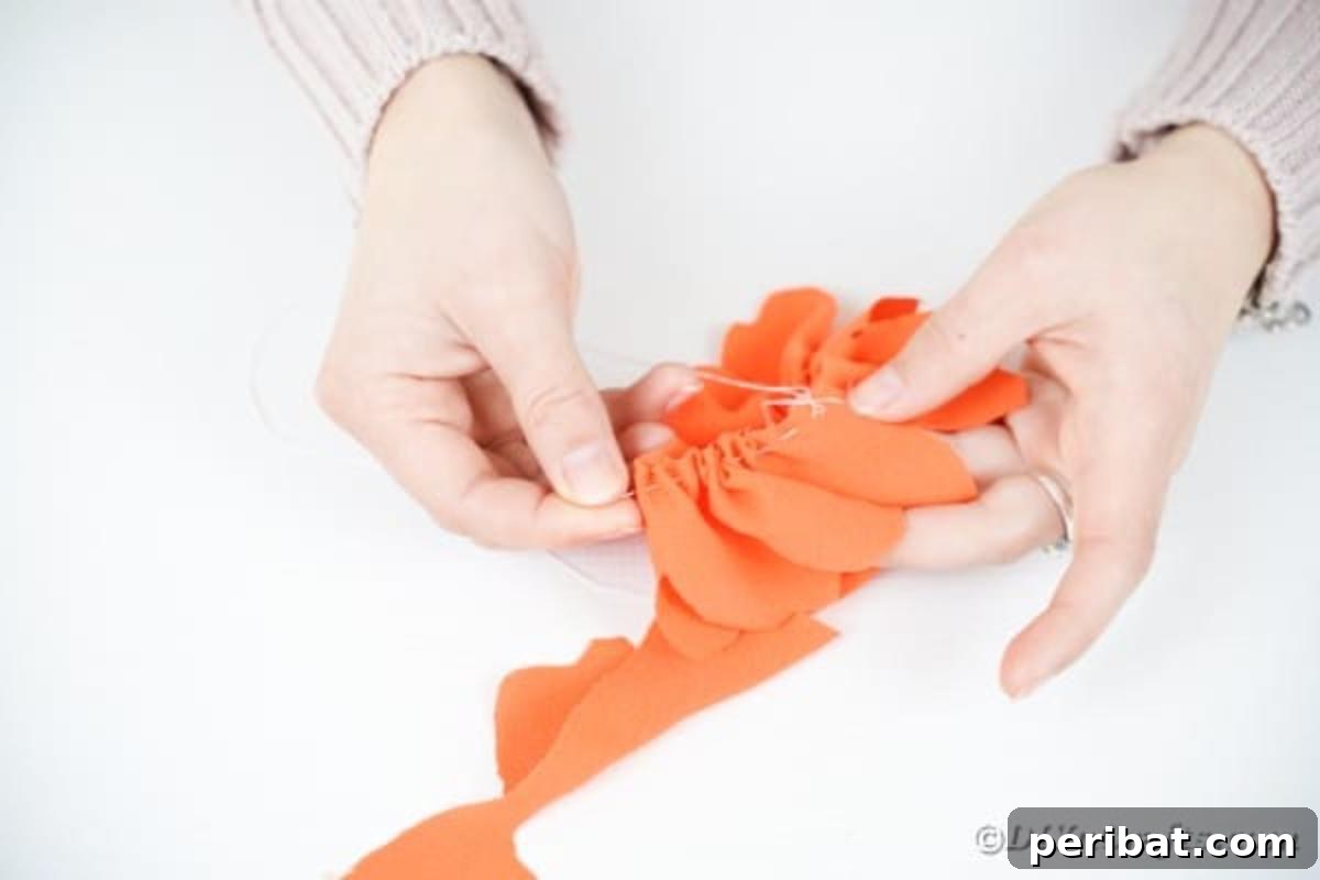 Your Easy Guide to Fabric Flower Bouquets Video 13 Sewing a long stitch along the edge of the orange fabric to gather it