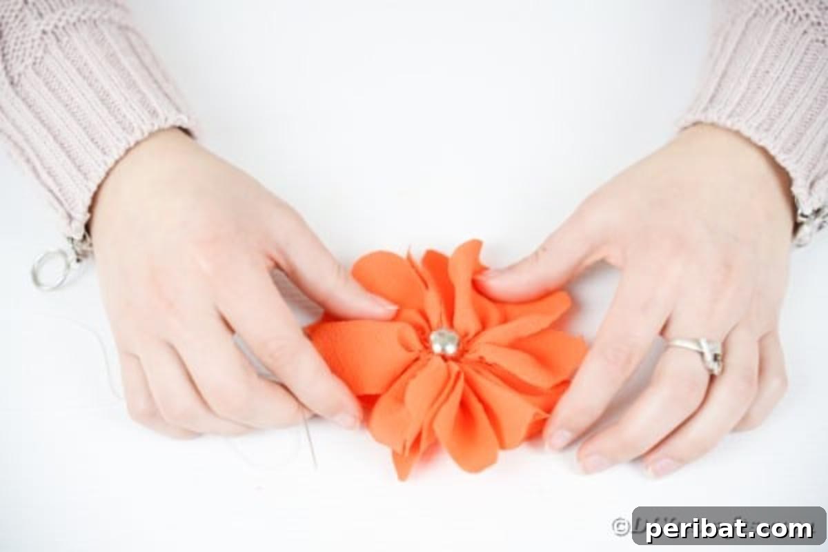 Your Easy Guide to Fabric Flower Bouquets Video 15 Adding a bead to the center of an orange fabric flower