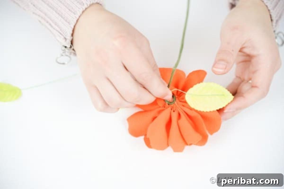 Your Easy Guide to Fabric Flower Bouquets Video 18 Adding an artificial leaf to the stem of a fabric flower
