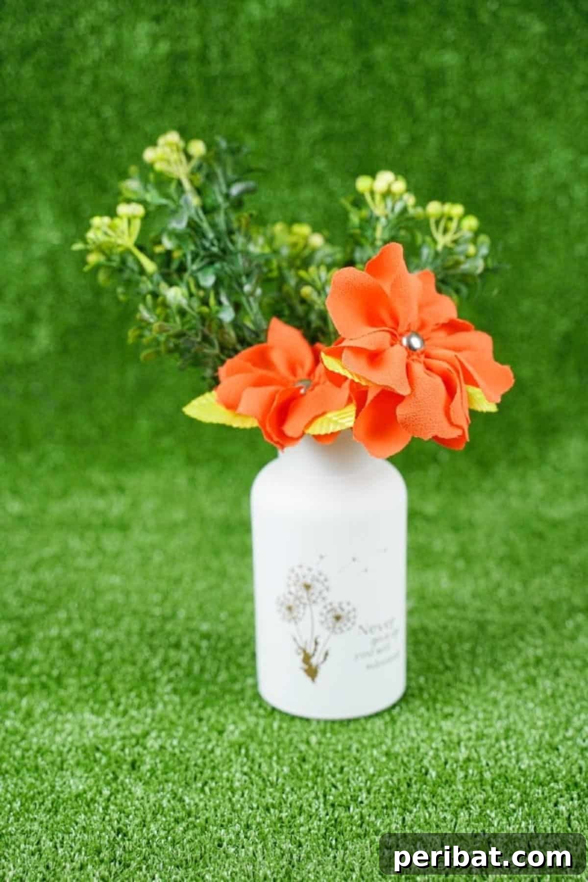 Your Easy Guide to Fabric Flower Bouquets Video 3 Orange flowers in white jar on grass, symbolizing freshness