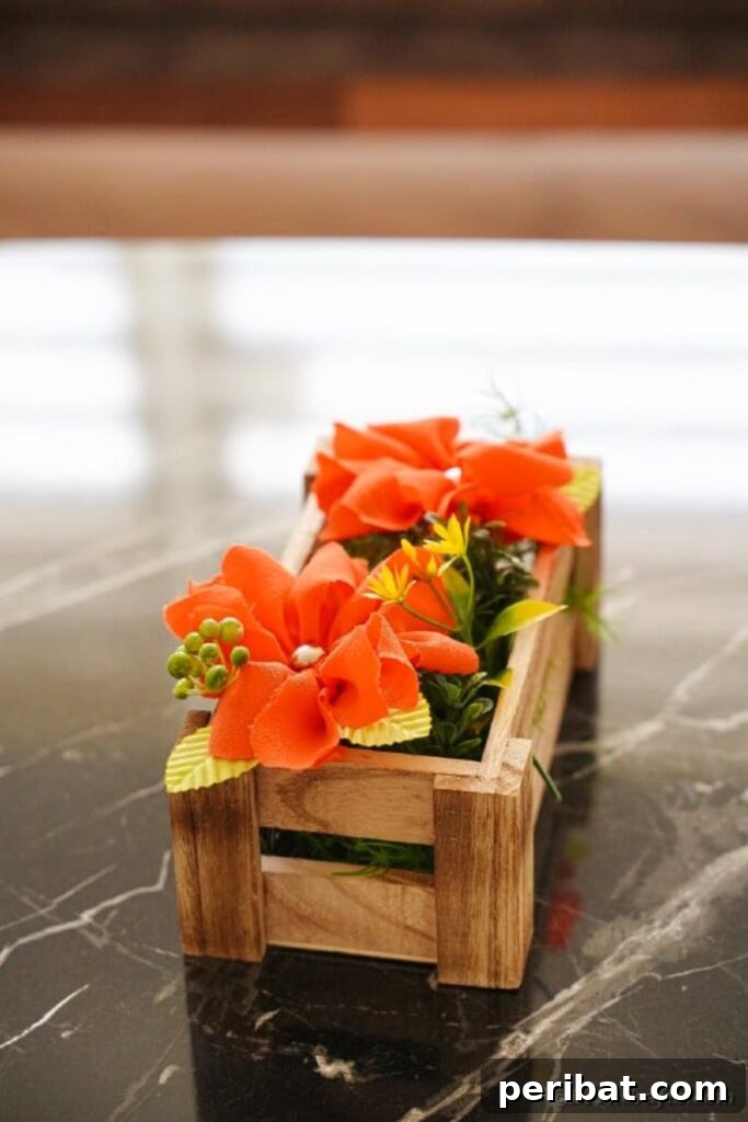Your Easy Guide to Fabric Flower Bouquets Video 21 Orange fabric flowers arranged neatly in a wooden box on a table