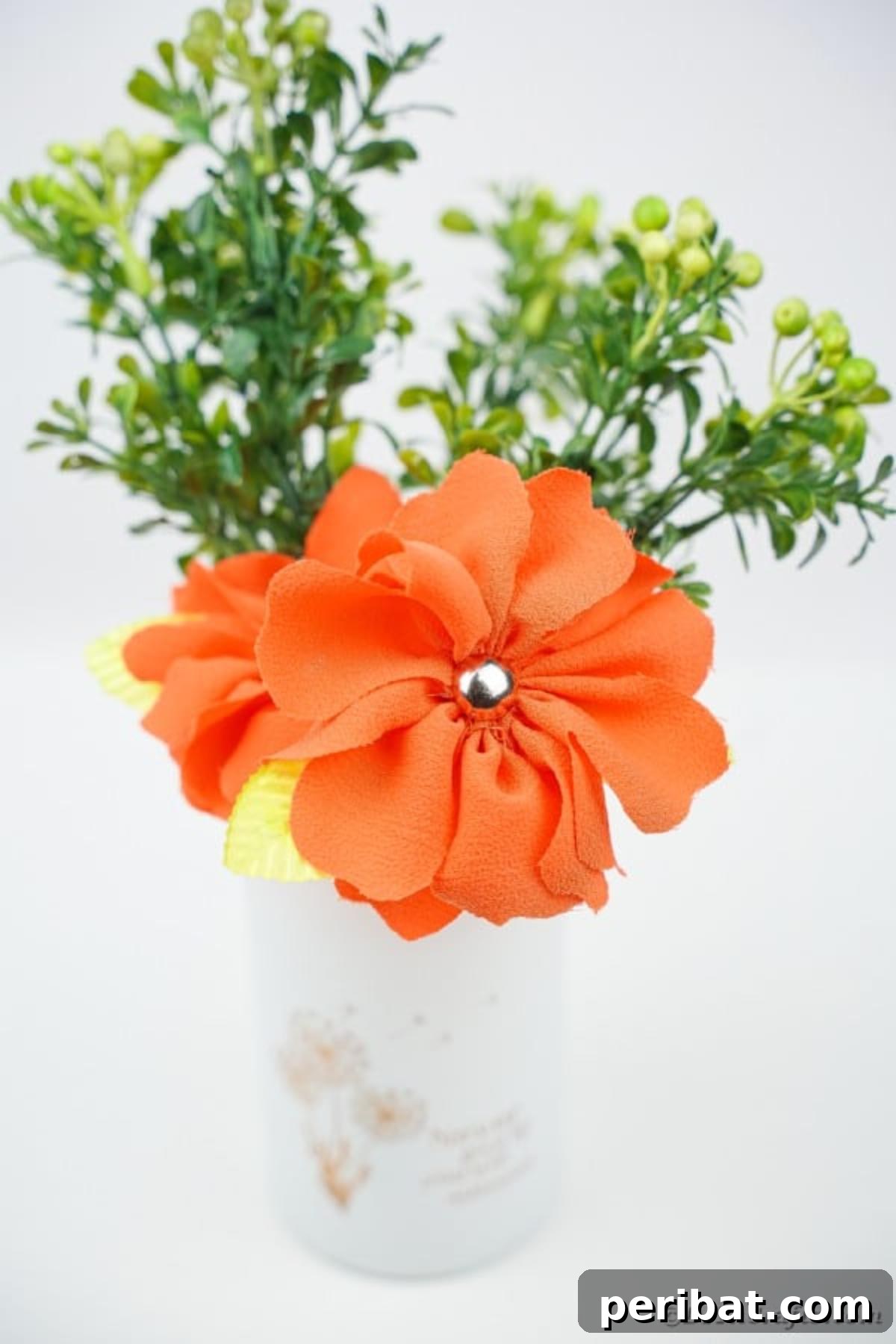 Your Easy Guide to Fabric Flower Bouquets Video 5 Single orange fabric flower elegantly placed in a white vase