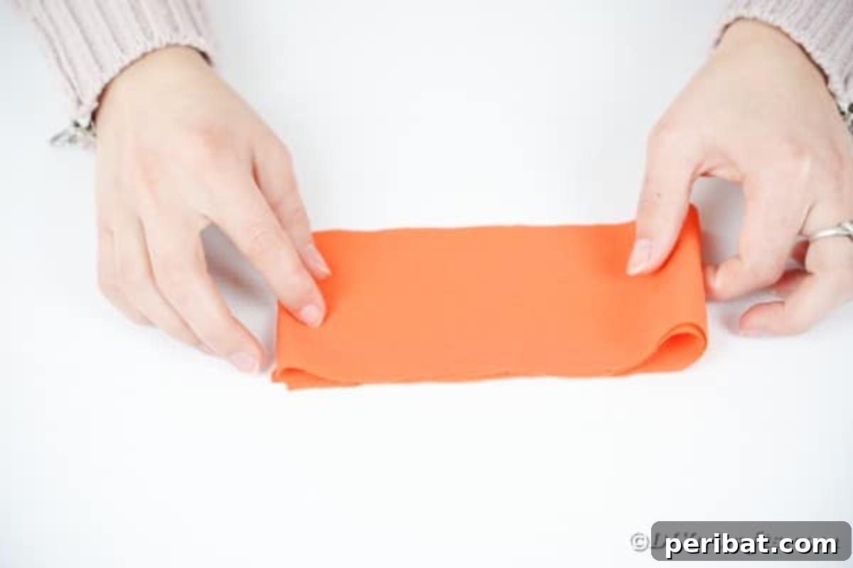 Your Easy Guide to Fabric Flower Bouquets Video 9 Folding a strip of orange fabric neatly