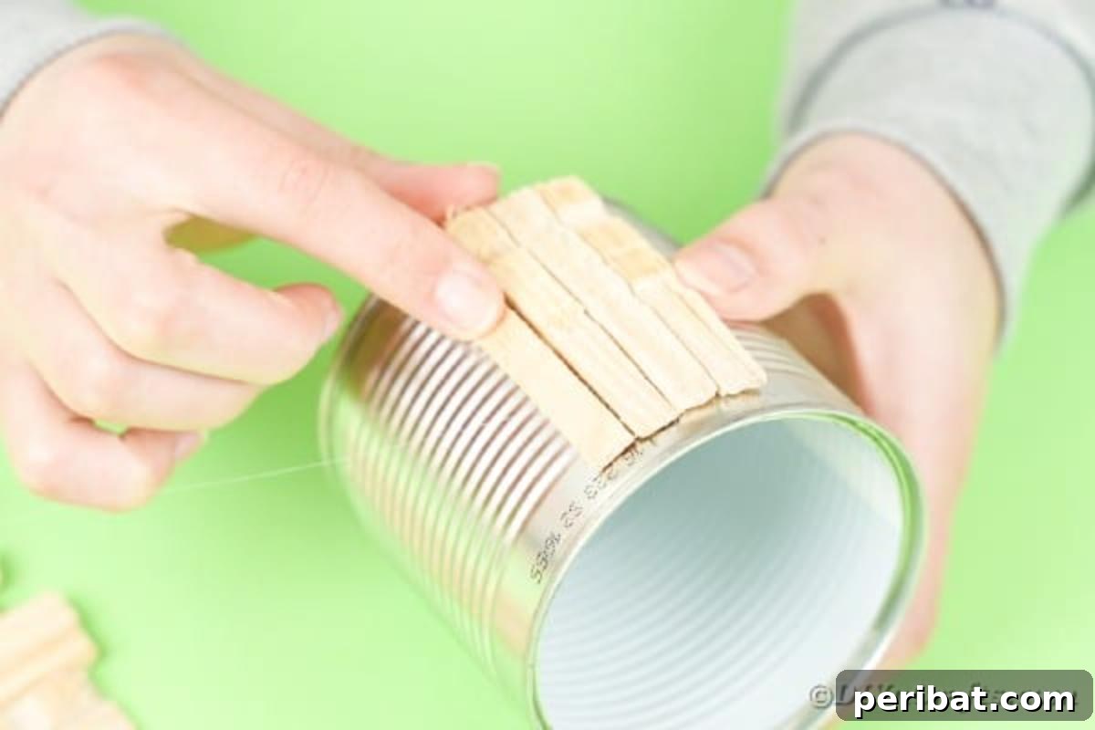 Pegged Tin Pot & Storage 11 Gluing separated clothespin pieces onto a tin can to cover its surface