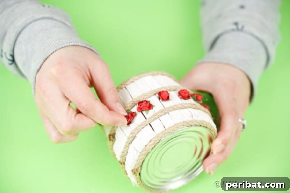 Pegged Tin Pot & Storage 14 Gluing miniature red roses as embellishments on the tin can organizer