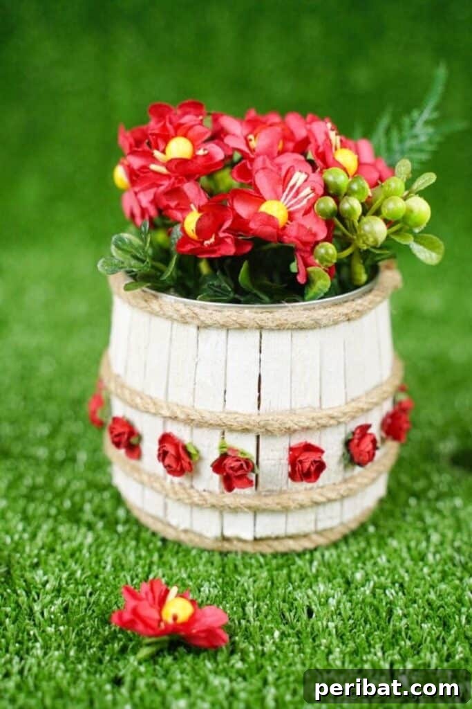 Pegged Tin Pot & Storage 26 Mini wooden barrel planter on grass with bright flowers, a charming outdoor accent