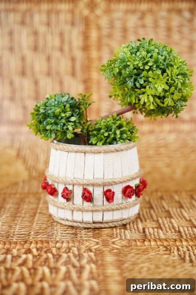 Pegged Tin Pot & Storage 30 Clothespin organizer can with lush greenery inside, showcasing its natural beauty