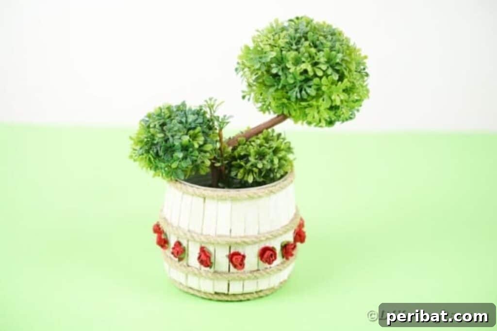 Pegged Tin Pot & Storage 31 Clothespin organizer can holding vibrant green plants on a rustic wooden surface
