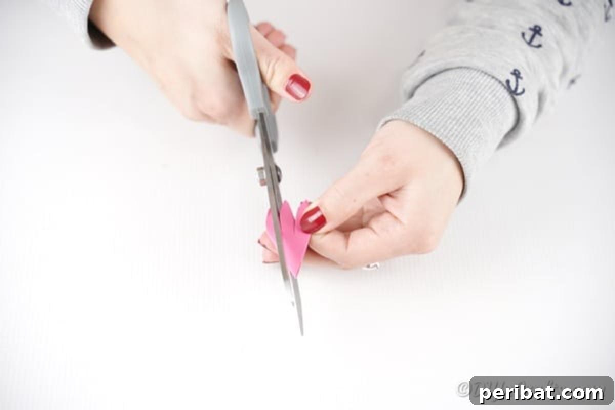 Cutting out pattern on paper flower